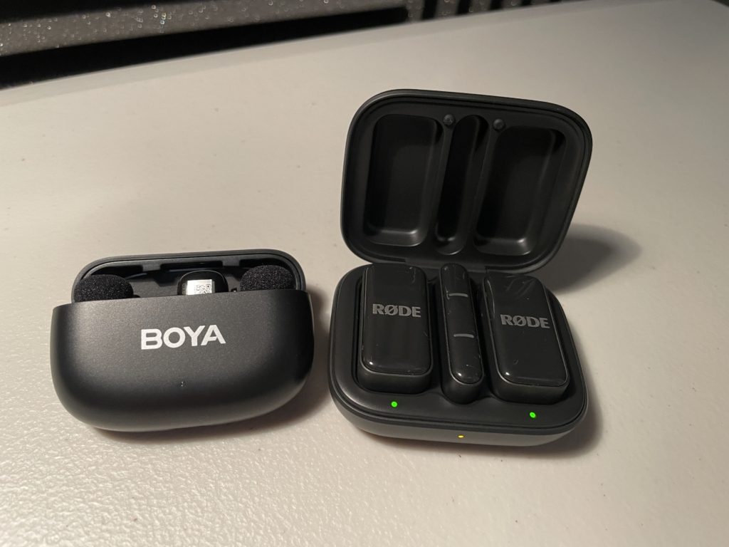 The BOYA Mini and Rode Wireless Micro in their charging cases