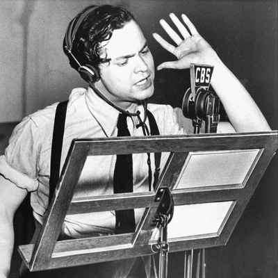 This photo of Orson Welles, voice acting in War of The Worlds, gets shared around nearly every time people mention audio drama or fiction podcasts, and makes a great Halloween costume for podcasters.